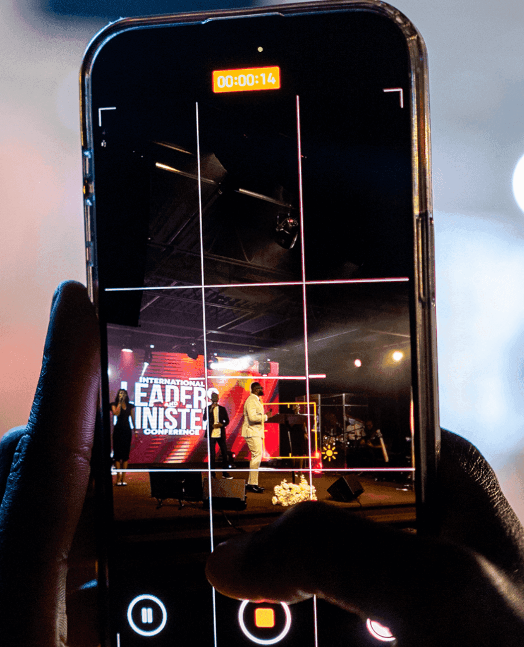 An attendee capturing the conference moment on their phone