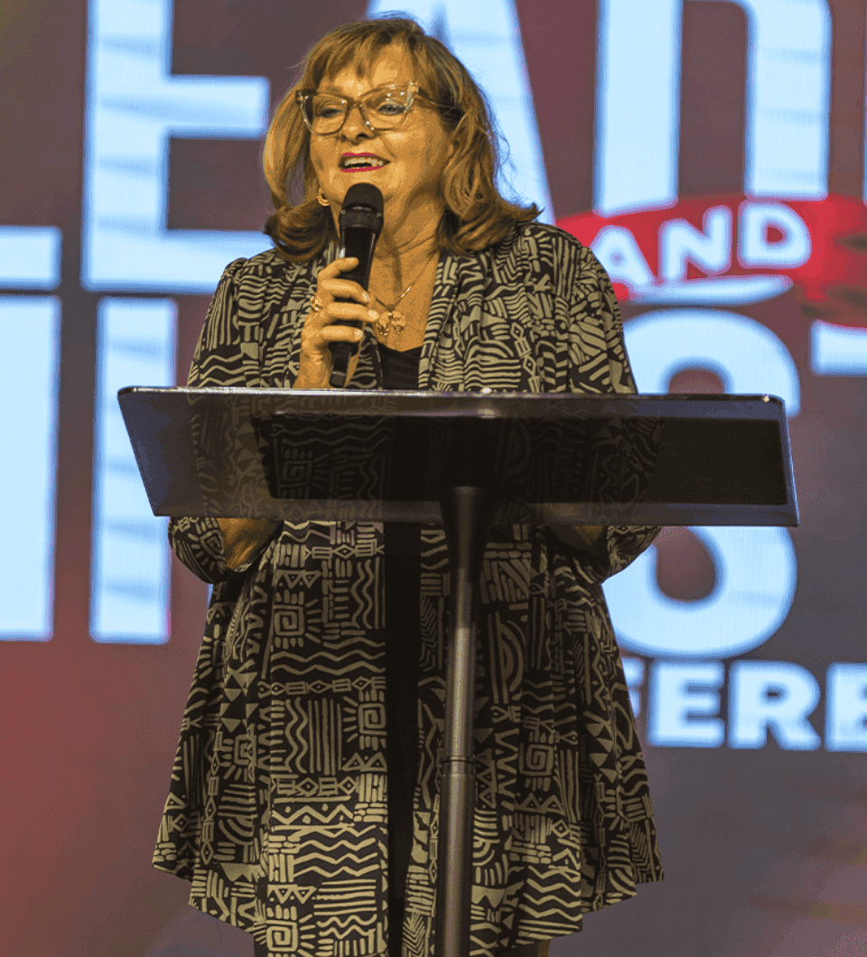 A guest speaker ministering from the podium at the conference