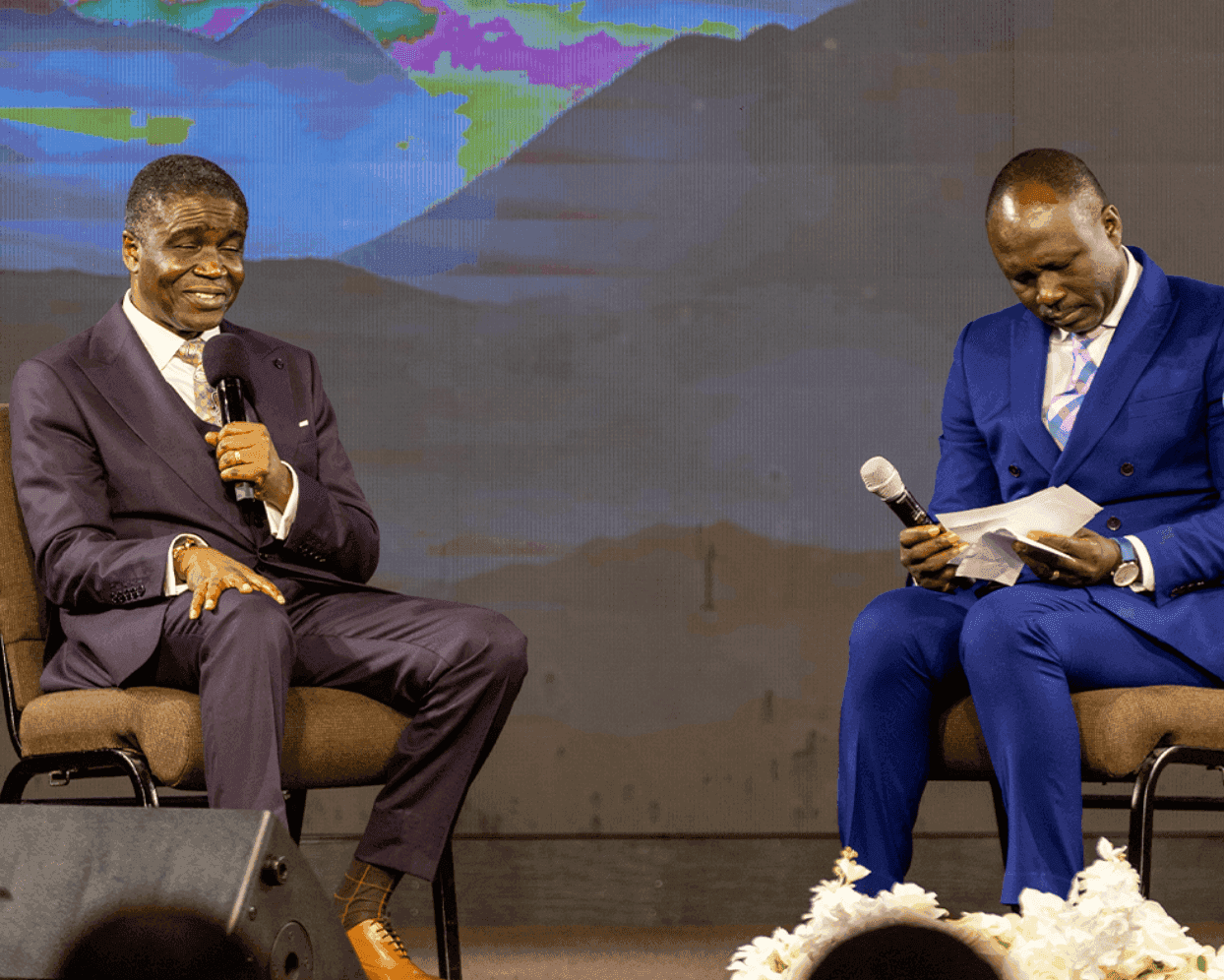 Two leaders in an intimate seated conversation on stage, sharing ministry insights