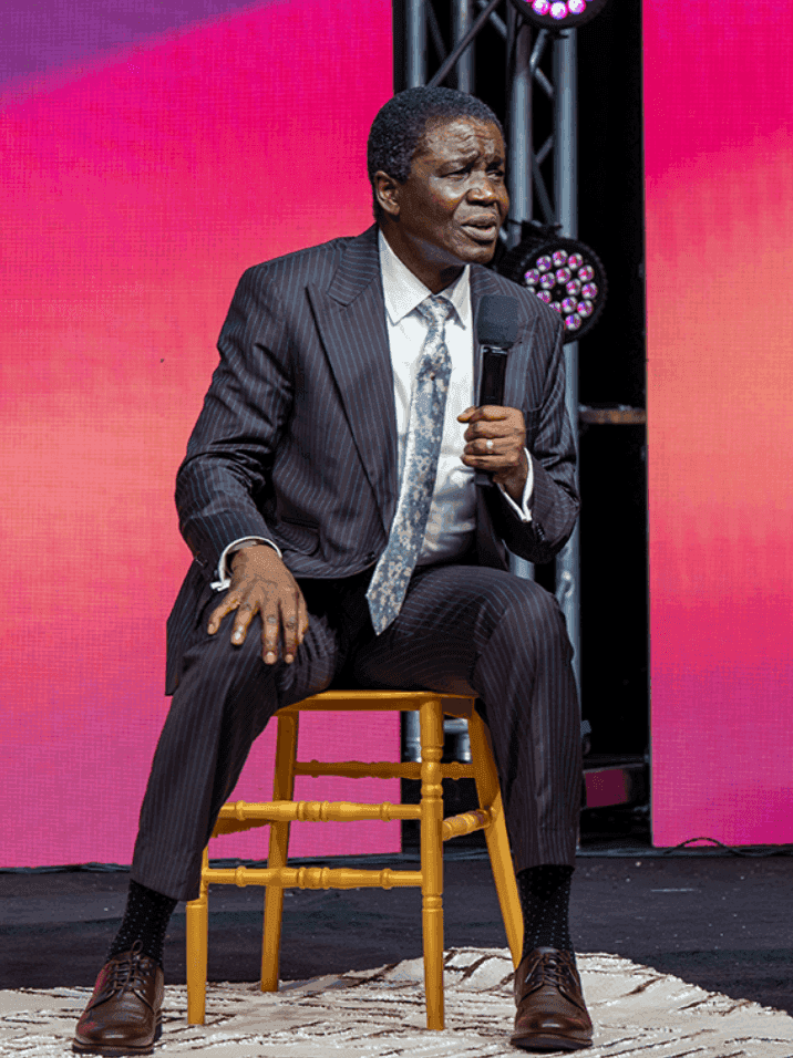 David Abioye speaking from a seated position, sharing wisdom in an intimate setting