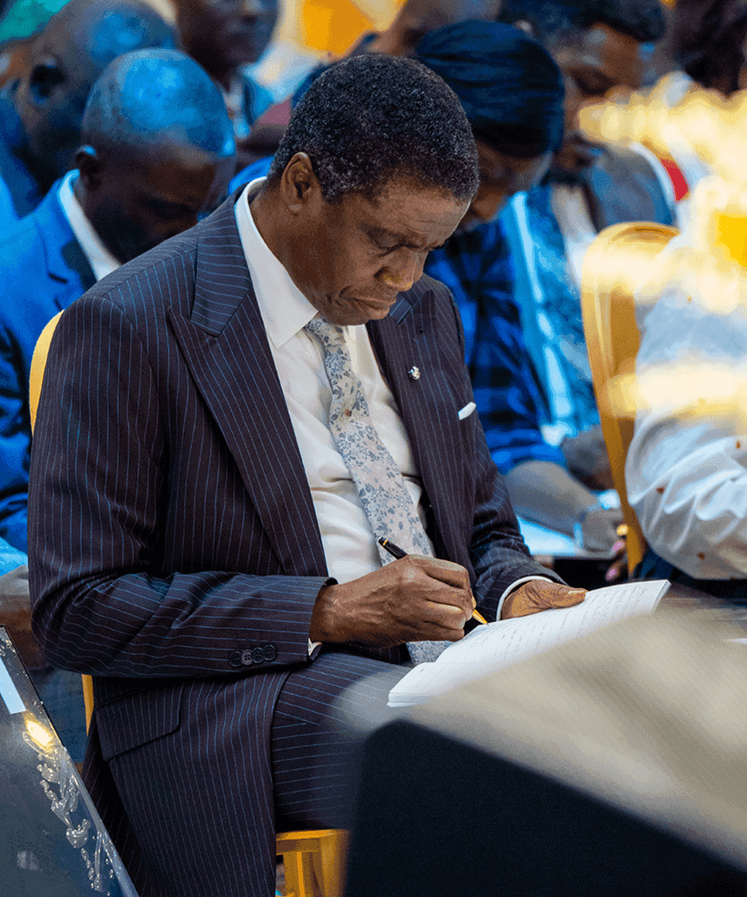 David Abioye seated among young ministers, taking notes alongside them