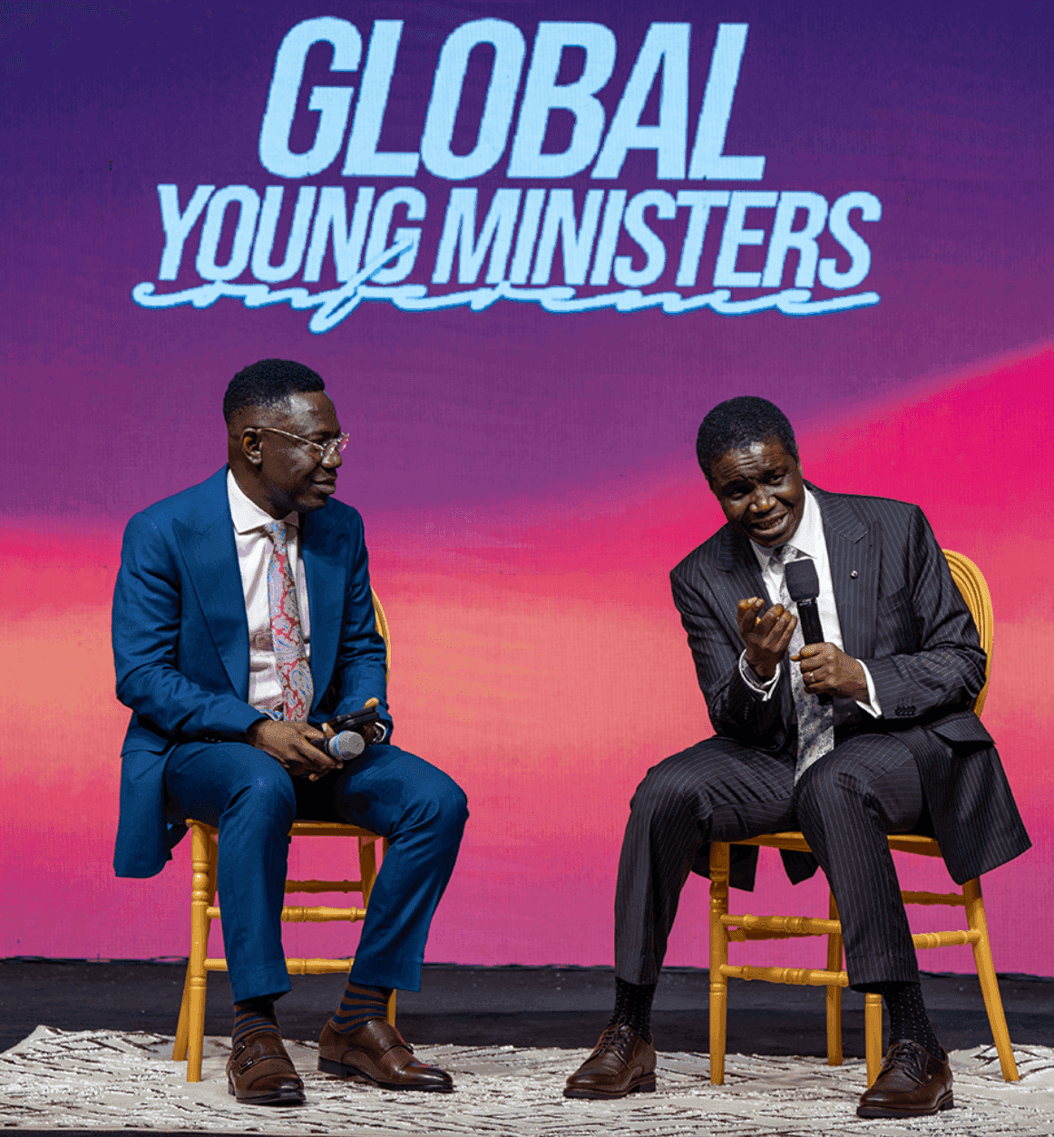 David Abioye in conversation with a young minister on stage at the Global Young Ministers Conference