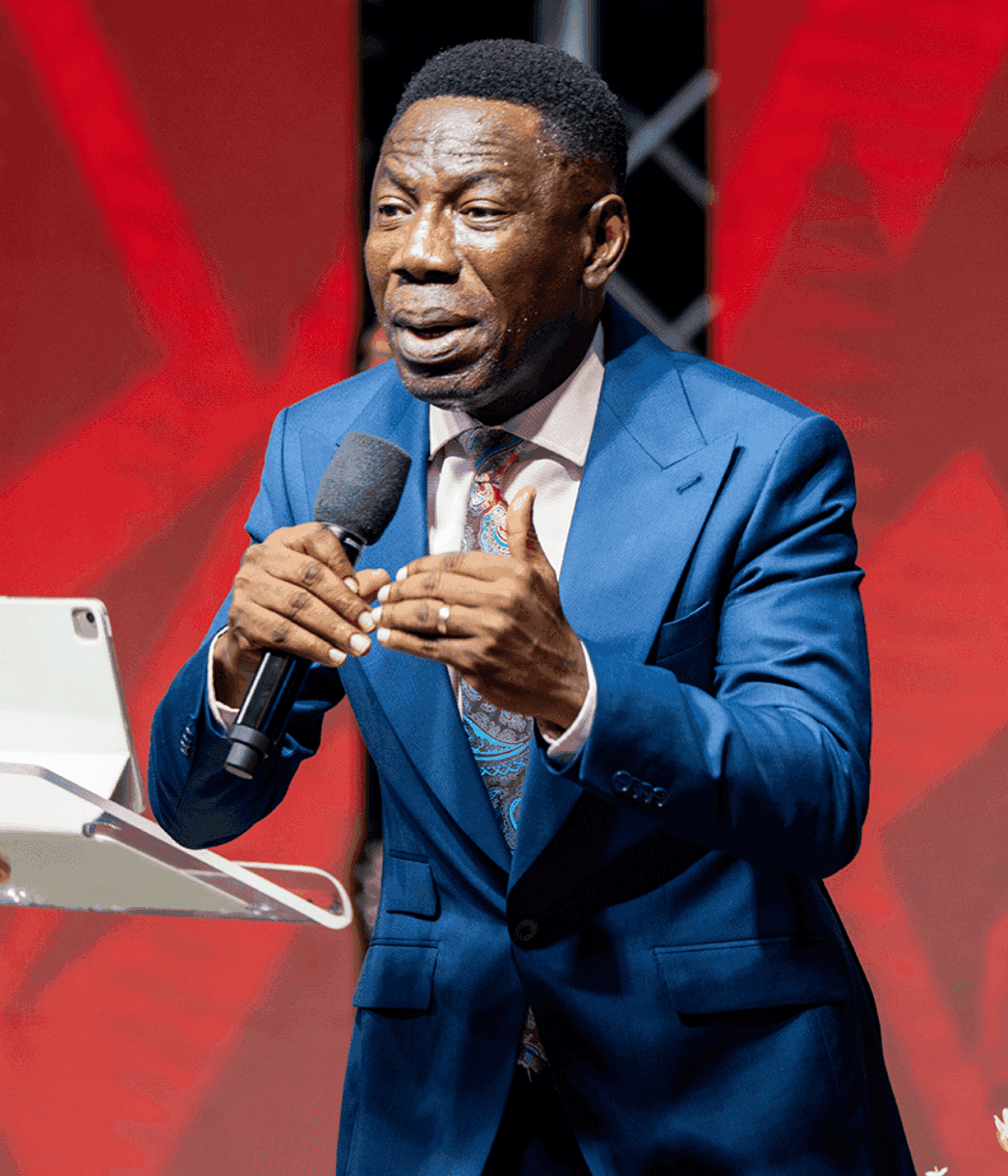 A young minister preaching with fire and conviction, microphone in hand against a red backdrop
