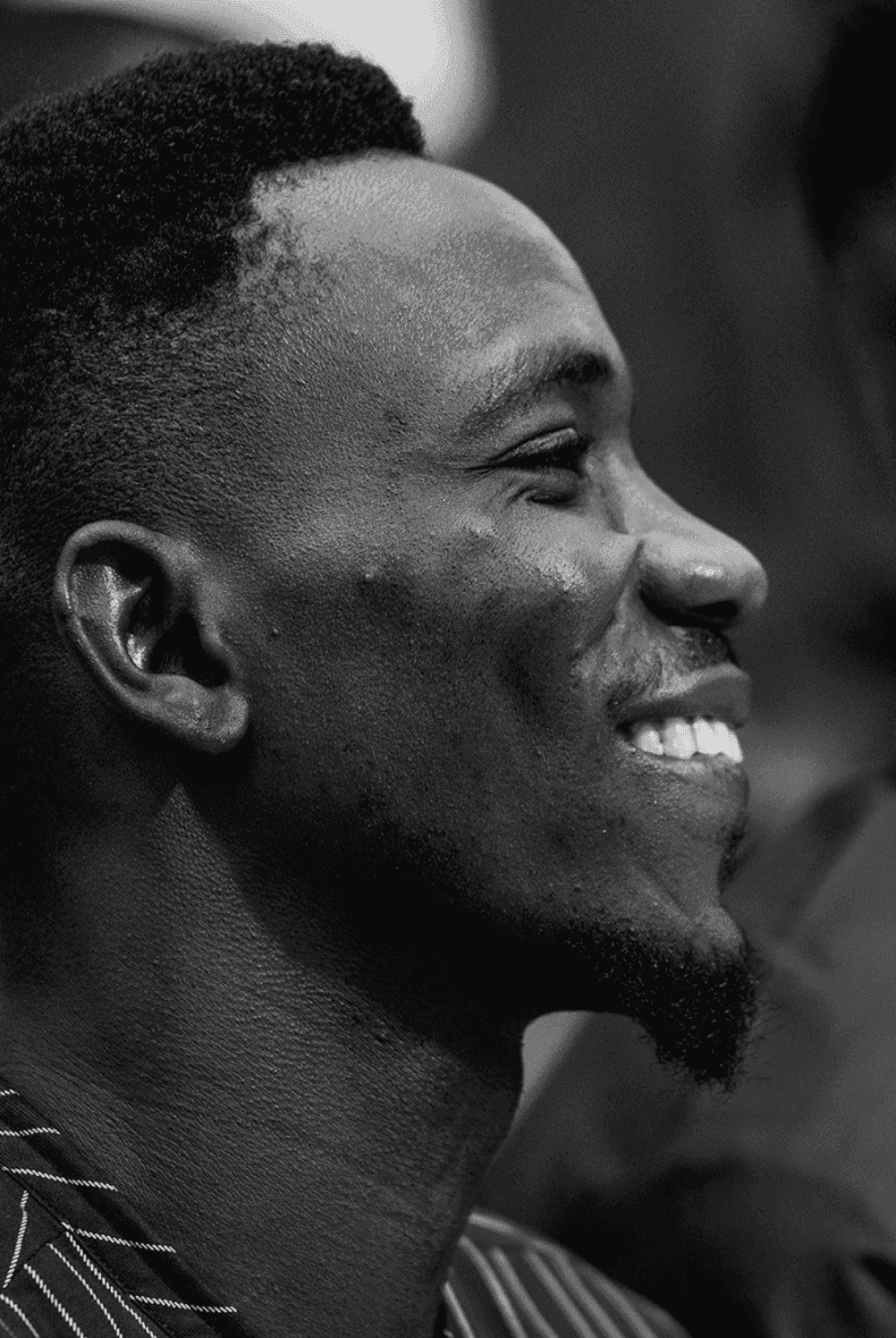 A young minister in profile, looking upward with a smile, a portrait of hope